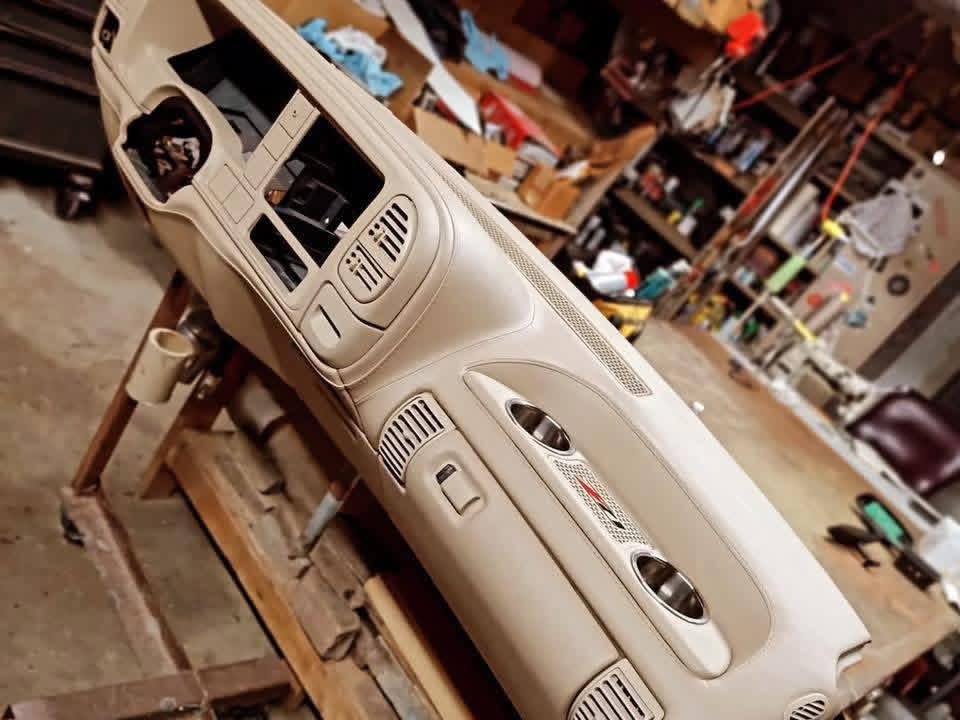 custom-wrapped dashboard designed for Chevrolet OBS trucks. It features premium upholstery with custom grill and cup holder inserts, priced at approximately $700.00.